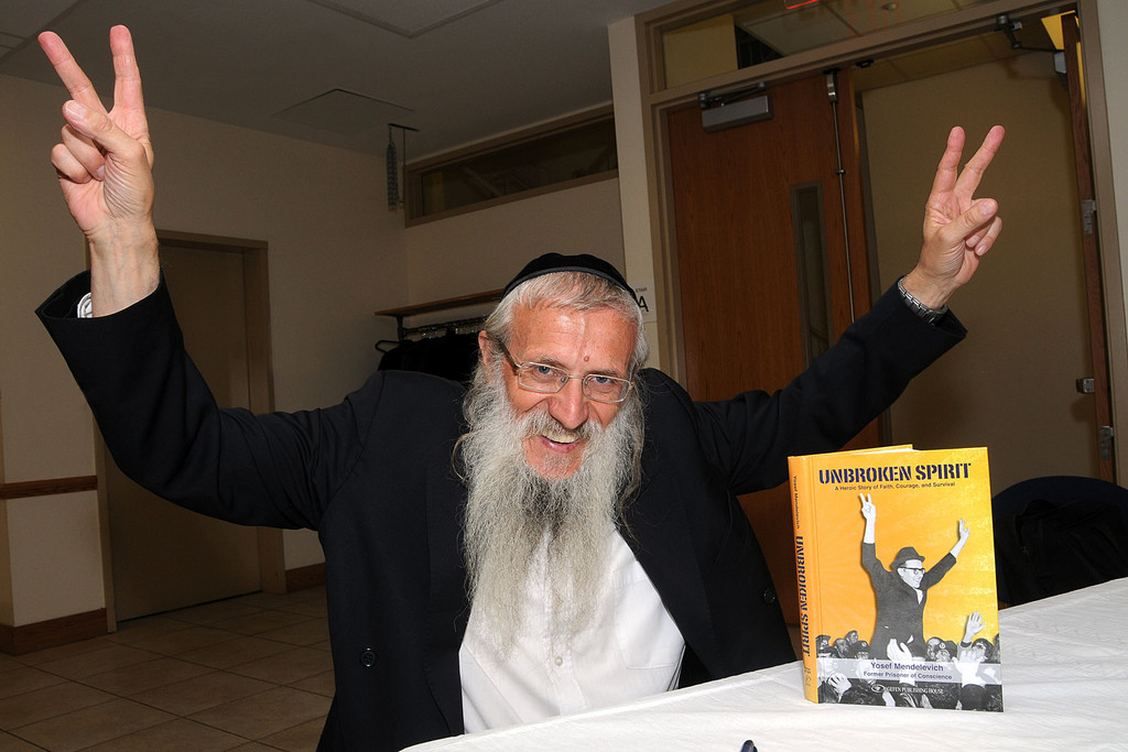 Rabbi Yosef Mendelevich displays his newly-translated autobiography, &ldquo;Unbroken Spirit: A Heroic Story of Faith, Courage and Survival.&rdquo;