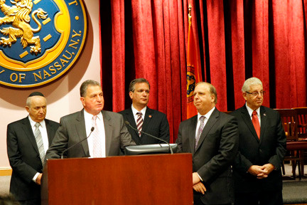 Detective Lt. John Azzata speaks as (l-r) Chaim's father Anton, Nasssau County Executive Ed Mangano, Chief of Detectives John &quot;Rick&quot; Capece and Police Department Rabbi Barry Dov Schwartz look on.