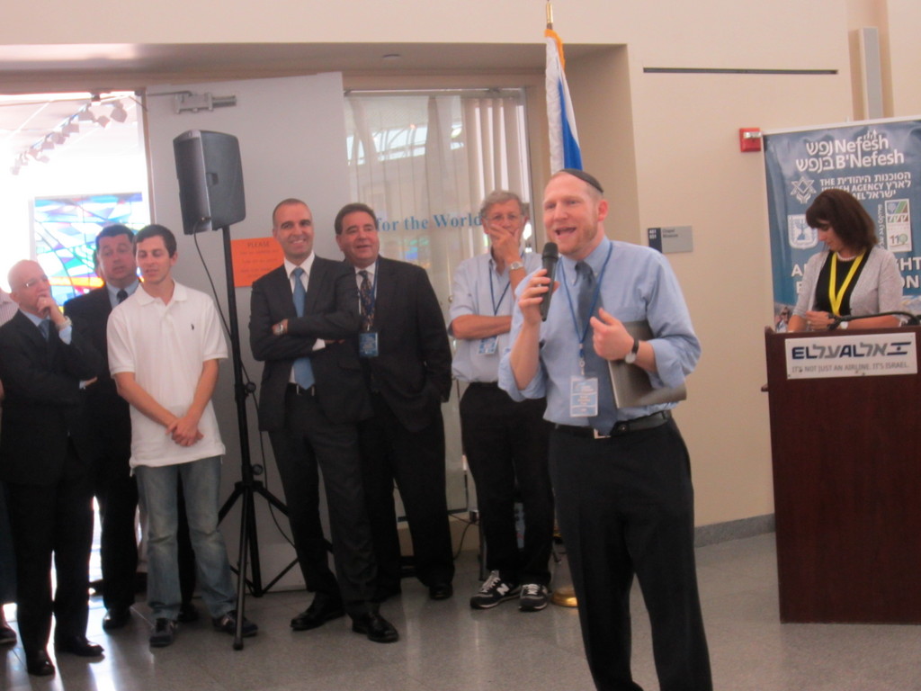 Rabbi Yehoshua Fass, NBN founder and executive director, speaks at JFK Airport last week before Nefesh B&rsquo;Nefesh&rsquo;s latest flight of olim (immigrants), flanked by (from left) Erez Halfon, vice chairman of NBN; Russell Robinson, CEO of Jewish National Fund; and Shamai Keinan, Karen Kayemet L&rsquo;Yisrael board member.