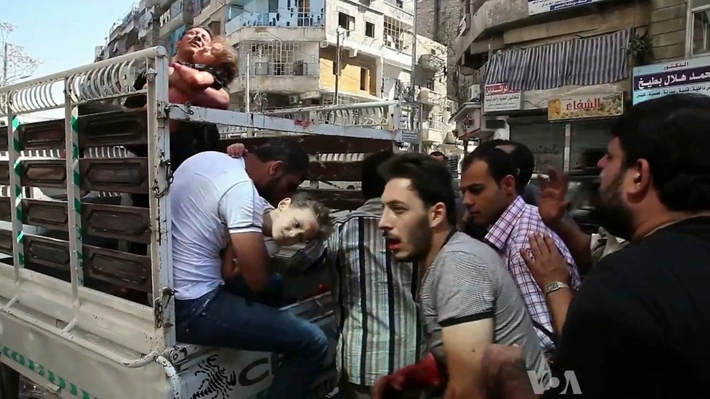 Wounded civilians arrive at a hospital in Aleppo during the Syrian civil war.