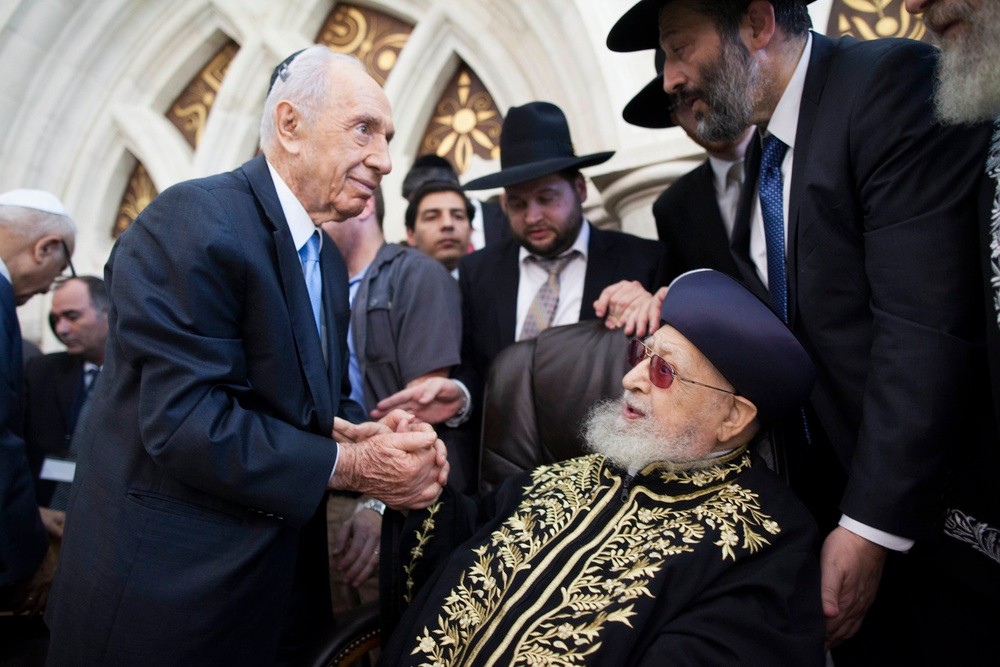 Rabbi Ovadia Yosef shakes hands with Israeli President Shimon Peres at a September 16 ceremony at the Rabban Yohanan Ben Zakai Synagogue in Jerusalem where his son, Rabbi Yitzhak Yosef, officially became the Sephardi Chief Rabbi of Israel.
