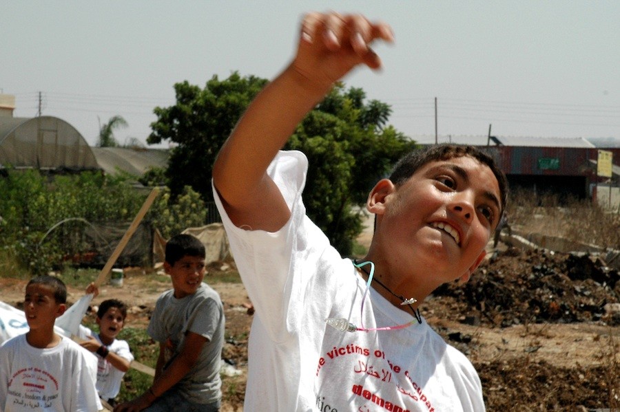 A Palestinian boy throws a stone at Israel