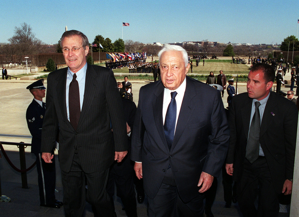 U.S. Secretary of Defense Donald H. Rumsfeld (left) escorts Israeli Prime Minister Ariel Sharon into the Pentagon on March 19, 2001.