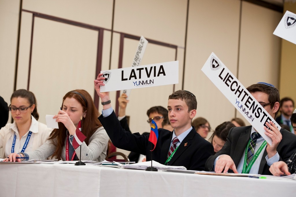 At the 24th annual Yeshiva University National Model United Nations, Natan Kelsey holds Latvia