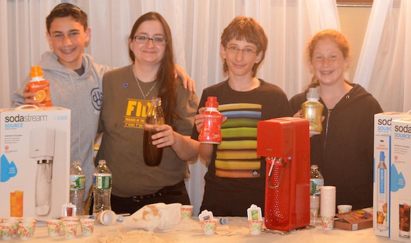 Left to Right: Eitan Markowit, 13, Avital Plotkin, 22, Jason Rodolitz, 14 and Jaimie Krueger, 12 at the Sodastream table.