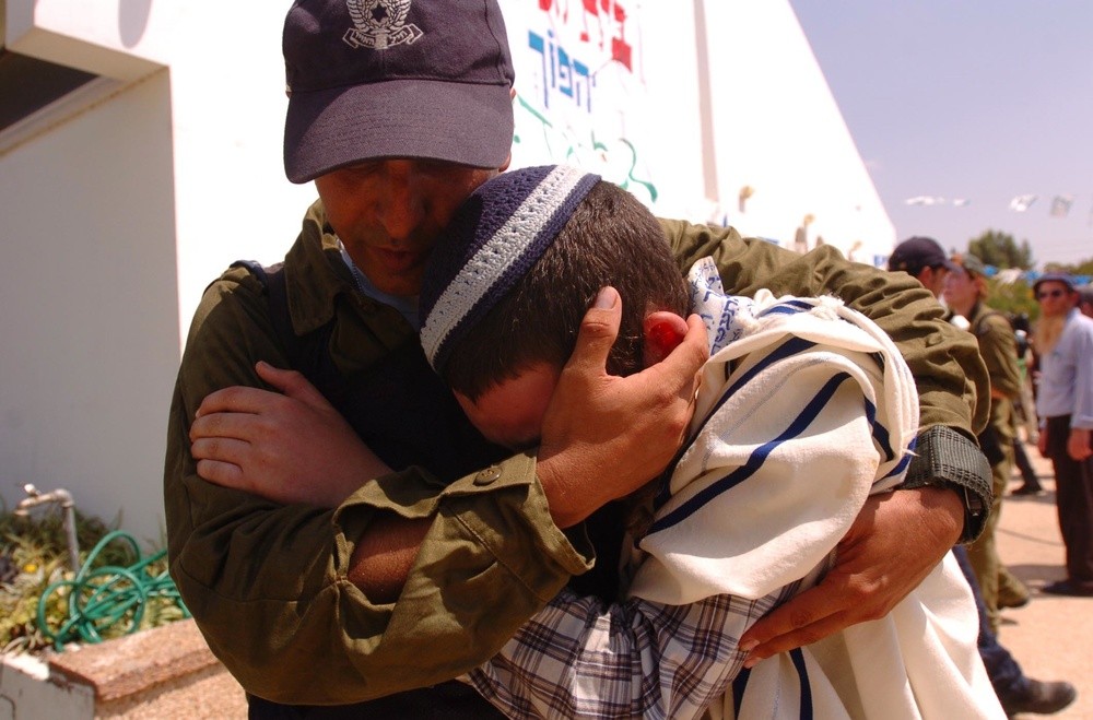 An Israeli soldier comforts a Jewish resident while evacuating the Israeli community of Morag during the August 2005 unilateral Israeli disengagement from Gaza.