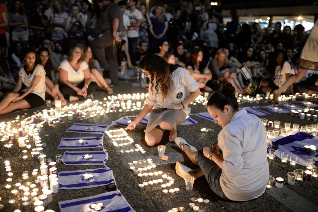 Israelis light candles in Tel Aviv's Rabin Square on Monday as they mourn the news of the death of three abducted Jewish teenagers. Israeli forces found the bodies of the three missing teenagers on Monday after a nearly three-week-long search.