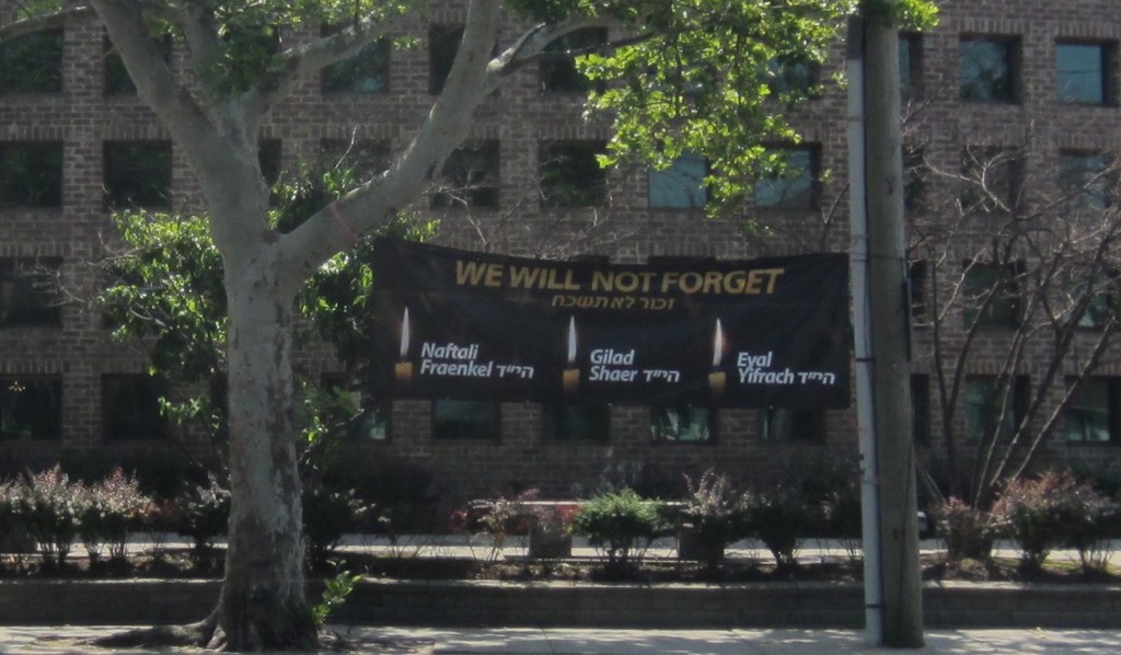 YI Woodmere displays a banner remembering Eyal, Naftali and Gil-ad.