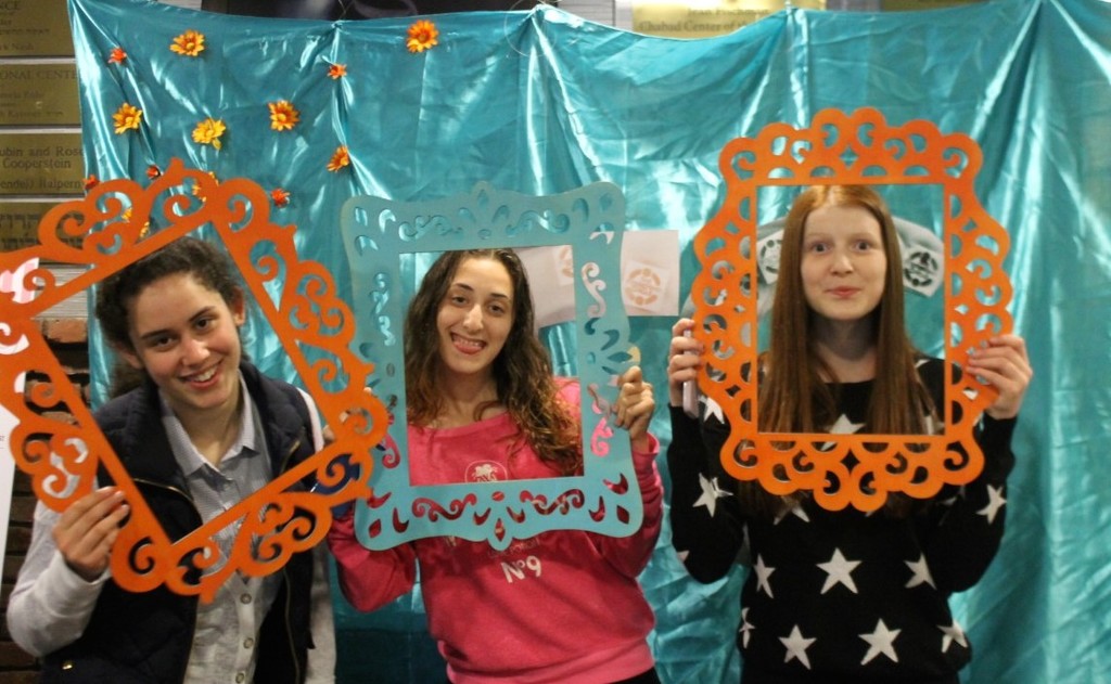 Friendship Circle volunteers Mindi Gelbtuch, Meira Flaum and Alana Eisner manned the photo booth during a celebration on May 28.