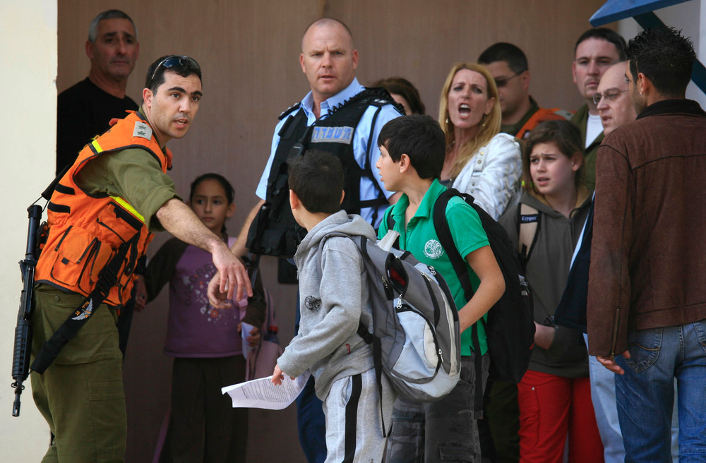 Students are evacuated from a school in the southern Israeli city of Sderot in 2009 after a Qassam rocket hit the building.