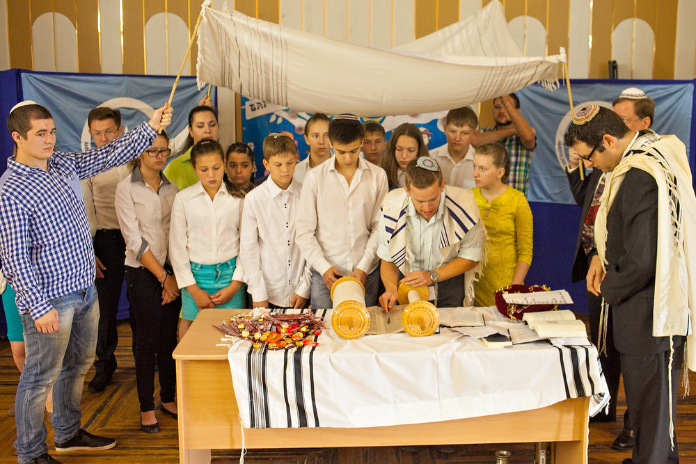 Participants in the Bar/Bat Mitzvah Family Camp reading from a Torah scroll in the Siberian city of Novosibirsk in August.