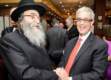 Rabbi David Niedelman, longtime executive director and president of the United Jewish Organizations of Williamsburg, greets veteran Brooklyn Democratic leader Steve Cohn.