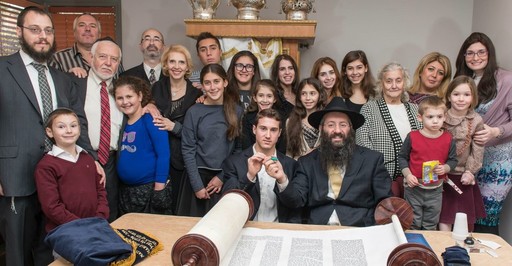 At left is Hewlett Chabad Rabbi Nochem Tenenboim. At center is the sofer, Rabbi Moshe Liberow of Southern California.