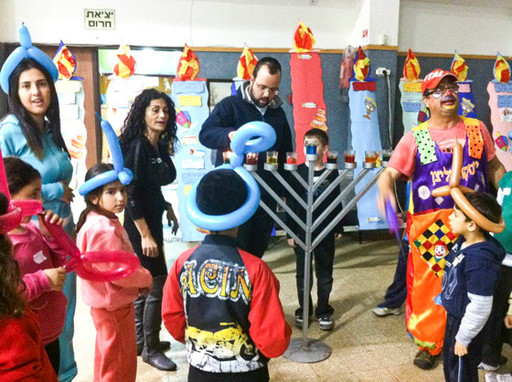 A Meir Panim Chanukah party, one of the group's activities that brings joy to Israelis in need.