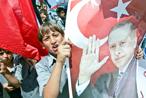 In Gaza City in 2011, Palestinian students hold up pictures of then Turkish prime minister and now President Recep Tayyip Erdogan during a rally that urged Erdogan to visit the Hamas-ruled Gaza Strip.