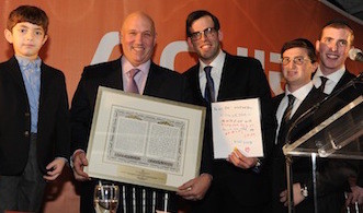 Physician Appreciation Award recipient Dr. Steven J. Schneider is flanked by 5-year-old Benny Kohn, who at 15 days was diagnosed with bleeding in the brain and treated by Dr. Schneider, and by Achiezer President Rabbi Boruch Ber Bender, Shalom Jaroslawicz (Hospital Support Services) and Eli Weiss (Development Coordinator).