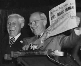 President Truman, shortly after being elected as President, smiles as he holds up a copy of the Chicago Tribune issue predicting his electoral defeat.