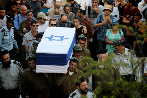 Friends and relatives mourn at the funeral of IDF Sgt. Barkey Ishai Shor, one of 66 Israeli soldiers killed during last summer