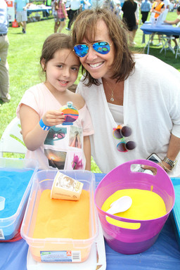 Fun with sand, Elianna Hercman helps Aviva Weber 5 with filling up her sand art.