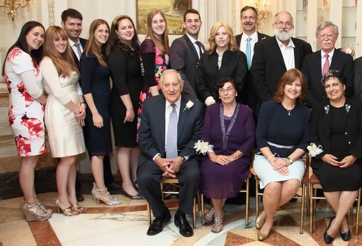 Guests of Honor Mark and Naomi Rubin of Lawrence are flanked by their family, standing at left, and (from right) former U.S. ambassador to the U.N. John Bolton (keynote speaker) and Ateret Cohanim Chairman Mati Dan HaKohen, guest of honor. Seated (from left): Ohev Yisrael Awardees, D. Bernard and Ann Hoenig, American Friends of Ateret Cohanim Vice-President Shani Hikind, and guest of honor Etya Dan.