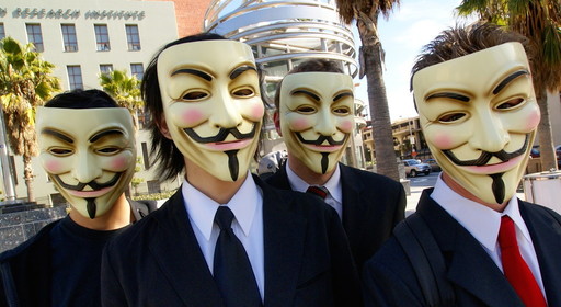 Four people in Los Angeles wearing the Guy Fawkes masks that have come to symbolize the global hacking network known as Anonymous.