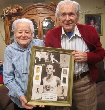 At home in Merrick, Walter Schacherl and his wife, Ryfka, display photographs of Walter in the 1950 Maccabiah Games.