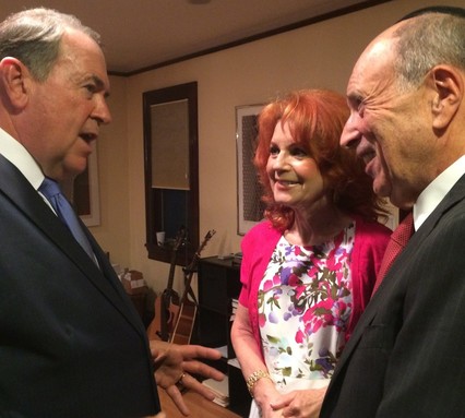 Mike Huckabee chats with Lawrence Mayor Martin and Reva Oliner, at Monday