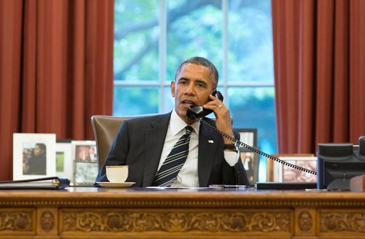 President Barack Obama talks with President Hassan Rouhani of Iran during a phone call in the Oval Office on Sept. 27, 2013.