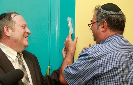 Shulamith Executive Director Rabbi Tirschwell and Tod Rothschild affix a mezuzah on Shulamith