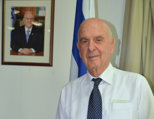 Israeli Ambassador to China Matan Vilnai pictured in his Beijing office. At top left is a picture of Israeli President Reuven Rivlin.