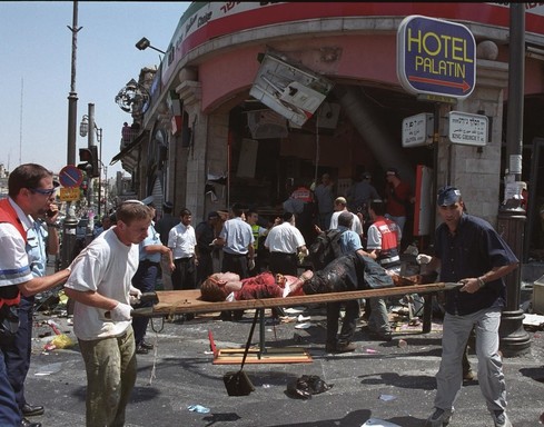 An injured girl is evacuated from the scene of a Palestinian suicide bombing at the Sbarro restaurant in Jerusalem Aug. 9, 2001.