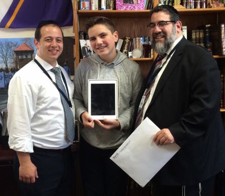 From left: Rabbi Jordan Nadelbach; Dani Kaufman, whose family donated the iPad, and Rabbi Gedaliah Oppen, at HAFTR.