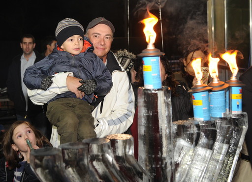 Barry Beshkin and 7-year-old Branden at the ice menorah for the third candle on Tuesday night.