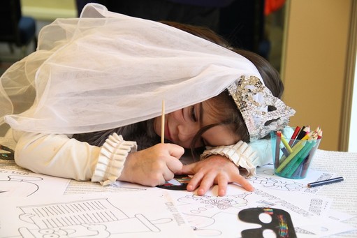 Putting final touches on Purim: Rivkah Shain, 8, colors a mask to complete her Purim costume, at the Chabad Learning Center in East Norwich, on Long Island&rsquo;s North Shore.