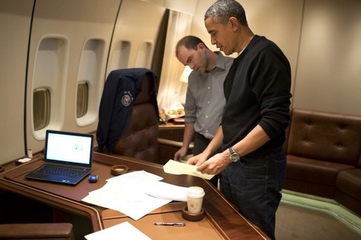 On Air Force One, President Obama watches Deputy National Security Adviser Ben Rhodes editing the speech that the president would deliver at the Nelson Mandela memorial service in South Africa.