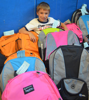 6-1/2 year old Michael Fuld, one of the volunteers who helped pack backpacks at YOSS.