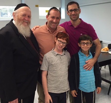 Pictured at left is Rabbi Benzion Kirsch, Middle School Rebbe; in the middle is Andrew Dube with his son Ami, and on the right is Brian Duftler with his son Boaz.