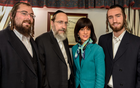 Rachel Freier in her Borough Park law office with, from left, nephew Shmuel Freier, husband David Freier, and son Mayer Freier.