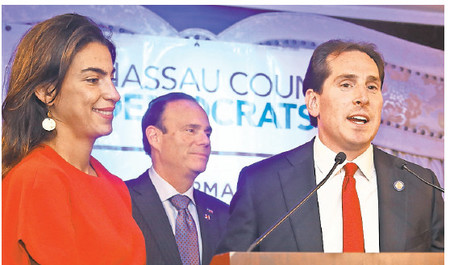 Democratic State Sen. Todd Kaminsky, with his wife, Ellen, and Nassau Democratic Chairman Jay Jacobs, proclaims victory over his Republican challenger, Chris McGrath.