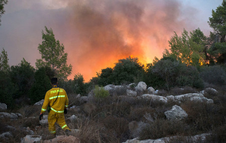 Fire fighters try to extinguish a wildfire which broke out iat the entrance to Nataf, outside of Jerusalem on Nov. 25.