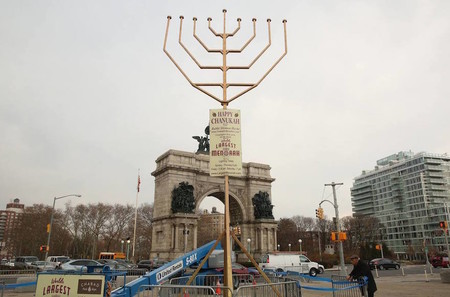 The Chabad menorah at Brooklyn Grand Army Plaza, whose candles reach 33 and a half feet in the air, is technically &mdash; but no longer officially &mdash; taller than its Manhattan rival.