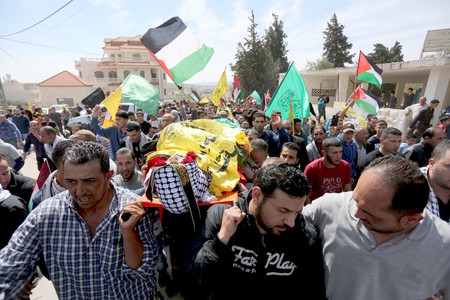 In March 2016 in the West Bank village of Deir Debwan, Palestinian mourners chant slogans while carrying the body of Mahmoud Shalan, who had tried to murder Israelis before security forces.