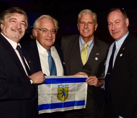Holding a Jerusalem flag, David Friedman is pictured at the Dec. 4 gala of American Friends of Bet El with Great Neck activist Dr. Paul Brody (left), Town of Hempstead Councilman Bruce Blakeman and Great Neck activist Jeffrey Wiesenfeld.