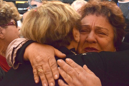 Holocaust-separated relatives Ryvka Borenstein Patchnik (left) and Fania Bilkay embrace for the first time at Yad Vashem in Jerusalem on Dec. 13.