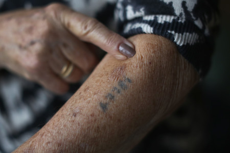 Auschwitz and Belsen concentration camp survivor Eva Behar shows her number tattoo.