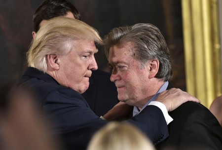 President Donald Trump congratulates Senior Counselor to the President Stephen Bannon during the swearing-in of senior staff in the East Room of the White House on Jan. 22.