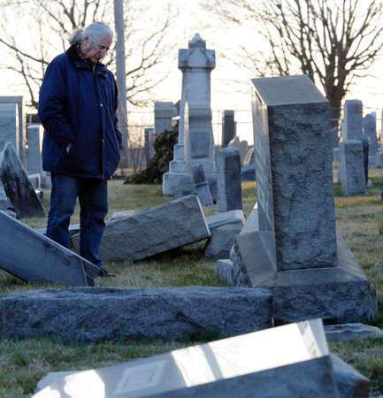 A man looks at fallen tombstones at the Mount Carmel Jewish cemetery in Philadelphia on Feb. 26.