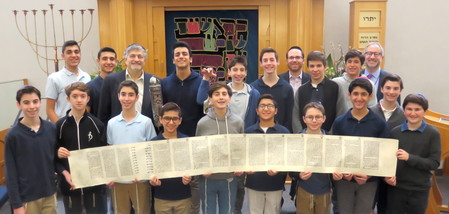 NSHA students prepared to read Megillat Esther with Dr. Paul Brody (back row, third from left, holding Megillah case); Rabbi Adam Acobas, Middle School principal (back row, fourth from right), and Rabbi Jeffrey Kobrin, head of school (back row, at far right).