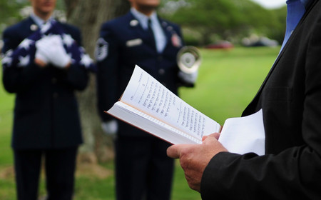 Daniel Bender, leader at the Lay Aloha Jewish Chapel, reads the Kelma&rsquo;male Rachamim prayer during a memorial service for Staff. Sgt. Jack Weiner.