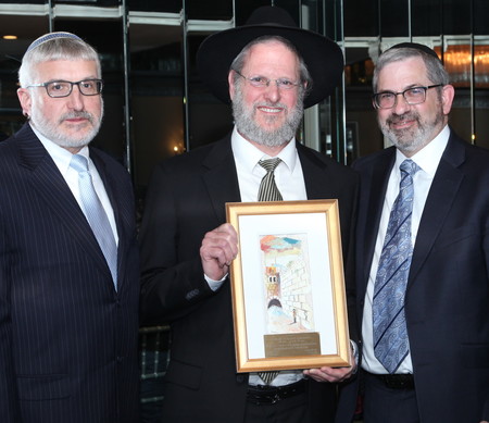 Rabbi Yitzchak Mark Friedman, Rebbe of Year, is flanked by Rabbi Yotav Eliach, Rambam;s principal (left). and Rabbi Zev Meir Friedman, rosh ha mesivta.